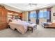 This is a bright primary bedroom featuring a ceiling fan, natural light, and built in cabinets at 2383 E Zion Way, Chandler, AZ 85249