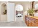 This is the entrance to the primary bedroom with an arched doorway and a large wooden dresser at 2383 E Zion Way, Chandler, AZ 85249