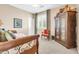 Inviting bedroom featuring stylish furniture, a large window, and neutral decor at 2383 E Zion Way, Chandler, AZ 85249