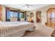 This is a spacious primary bedroom featuring a ceiling fan and a seating area near the windows at 2383 E Zion Way, Chandler, AZ 85249
