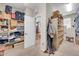 Large walk-in closet with custom shelving, drawers, and easy access to the primary bathroom at 2383 E Zion Way, Chandler, AZ 85249