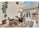 Bright dining area with an elegant chandelier, a glass table, and access to the outdoor space at 2383 E Zion Way, Chandler, AZ 85249