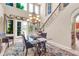 Dining area with a chandelier, a glass table with seating for four, and grand windows overlooking the yard at 2383 E Zion Way, Chandler, AZ 85249