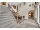 Grand entryway featuring a curved staircase, high ceilings, and elegant chandelier over the dining area at 2383 E Zion Way, Chandler, AZ 85249