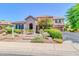 Lovely home with a stone facade, complemented by mature trees and lush landscaping at 2383 E Zion Way, Chandler, AZ 85249
