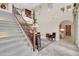 Spacious foyer featuring a staircase, decorative railing, a chandelier, tile flooring, and high ceilings at 2383 E Zion Way, Chandler, AZ 85249