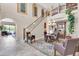 Grand foyer featuring a staircase with decorative railing, chandelier, arched doorways, and tile flooring at 2383 E Zion Way, Chandler, AZ 85249