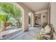 Inviting front porch with arched entryways, comfortable seating, and lush landscaping at 2383 E Zion Way, Chandler, AZ 85249