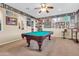Spacious game room featuring a pool table, custom wall decor, and ample entertainment space at 2383 E Zion Way, Chandler, AZ 85249