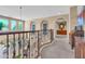 Elegant hallway featuring arched doorways, decorative railings, and plenty of natural light at 2383 E Zion Way, Chandler, AZ 85249