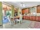 Bright kitchen featuring wood cabinets, large sliding windows, and a cozy dining table at 2383 E Zion Way, Chandler, AZ 85249