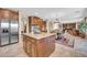 Open-concept kitchen with island seating seamlessly connects to a dining area and living space at 2383 E Zion Way, Chandler, AZ 85249