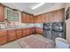 Functional laundry room with storage cabinets and a stainless steel washer and dryer at 2383 E Zion Way, Chandler, AZ 85249
