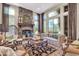 Inviting living room with a stone fireplace, a decorative rug, comfortable seating, and bright natural light at 2383 E Zion Way, Chandler, AZ 85249