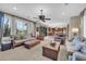 Spacious living room featuring large windows, comfortable seating, and an open floor plan at 2383 E Zion Way, Chandler, AZ 85249