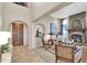 Open-concept living area with a stone fireplace, comfortable seating, tile flooring, and stylish decor at 2383 E Zion Way, Chandler, AZ 85249