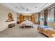 Large bedroom with coffered ceilings, carpet, and a spacious seating area by large windows at 2383 E Zion Way, Chandler, AZ 85249