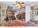 Bright and eclectic office featuring a roll top desk, patterned rug, and ceiling fan at 2383 E Zion Way, Chandler, AZ 85249