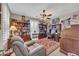 Cozy home office with built-in bookshelves, comfortable seating, and a ceiling fan at 2383 E Zion Way, Chandler, AZ 85249