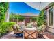 Cozy patio area with comfortable seating, lush greenery, and a decorative wooden gate at 2383 E Zion Way, Chandler, AZ 85249