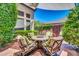 Charming backyard patio featuring a fire pit with seating, lush landscaping, and stone pavers at 2383 E Zion Way, Chandler, AZ 85249