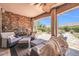 Inviting covered patio with stone fireplace and comfortable seating, perfect for outdoor relaxation at 2383 E Zion Way, Chandler, AZ 85249