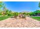Scenic backyard with a rock water feature, lush plants, and a stone patio at 2383 E Zion Way, Chandler, AZ 85249