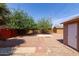 Large backyard featuring mature trees, a storage shed, and ample space, perfect for outdoor activities at 240 N Monte Vista St, Chandler, AZ 85225