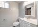 Bathroom featuring white vanity and commode, framed mirror, and tiled shower at 240 N Monte Vista St, Chandler, AZ 85225