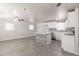 Open-concept living space featuring gray floors, a ceiling fan, and a modern kitchen, perfect for gatherings at 240 N Monte Vista St, Chandler, AZ 85225