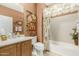 Bathroom featuring a single sink vanity, tile flooring, bathtub, and a decorative floral shower curtain at 27244 W Potter Dr, Buckeye, AZ 85396
