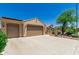 Charming home featuring a two-car garage, desert landscaping, tile roof, and solar panels at 27244 W Potter Dr, Buckeye, AZ 85396