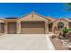 Charming home featuring a well-manicured desert landscape, a two-car garage, and a tile roof at 27244 W Potter Dr, Buckeye, AZ 85396