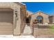 Charming front porch with gated entry, tile flooring, and textured stucco walls at 27244 W Potter Dr, Buckeye, AZ 85396