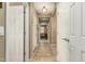 Long hallway with tiled floors, connecting the various rooms of the home at 27244 W Potter Dr, Buckeye, AZ 85396