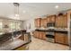 Well-equipped kitchen features granite countertops, wood cabinets, and stainless steel appliances at 27244 W Potter Dr, Buckeye, AZ 85396