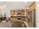 Kitchen features stainless steel appliances, granite counters, and tile backsplash, offering a modern design at 27244 W Potter Dr, Buckeye, AZ 85396