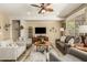 Spacious living room with tile floors, neutral walls, a ceiling fan, and comfortable seating at 27244 W Potter Dr, Buckeye, AZ 85396