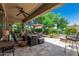 Relaxing covered patio with comfortable seating, ceiling fan and fire pit at 27244 W Potter Dr, Buckeye, AZ 85396