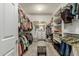 Spacious walk-in closet with shelving and hanging space, and bench seat with storage at 27244 W Potter Dr, Buckeye, AZ 85396