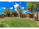 Large backyard with lush green lawn, mature trees, firepit, and well-maintained landscaping at 2748 E Dennisport Ave, Gilbert, AZ 85295