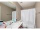 Bathroom featuring a shower-tub combination, light tiling, and a large mirror at 2748 E Dennisport Ave, Gilbert, AZ 85295