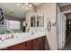 Well-lit bathroom with double sink vanity, large mirror, and access to closet at 2748 E Dennisport Ave, Gilbert, AZ 85295