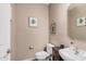 Cozy powder room with earth-toned walls, modern vanity, and a wall mirror at 2748 E Dennisport Ave, Gilbert, AZ 85295