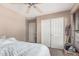 Clean bedroom featuring white bedding, carpeting, and a double-door closet at 2748 E Dennisport Ave, Gilbert, AZ 85295