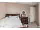 Bedroom featuring a three-drawer dresser, white bedding, and carpeting at 2748 E Dennisport Ave, Gilbert, AZ 85295
