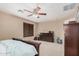 Bedroom featuring neutral carpeting, a ceiling fan, and a dark wood dresser and bedframe at 2748 E Dennisport Ave, Gilbert, AZ 85295