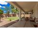 Relaxing covered patio with seating area overlooking the beautifully landscaped backyard at 2748 E Dennisport Ave, Gilbert, AZ 85295