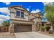 Attractive home featuring a two-car garage, stone accents, and tasteful landscaping at 2748 E Dennisport Ave, Gilbert, AZ 85295
