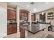 Spacious kitchen with dark cabinets, stainless appliances, and a granite island at 2748 E Dennisport Ave, Gilbert, AZ 85295